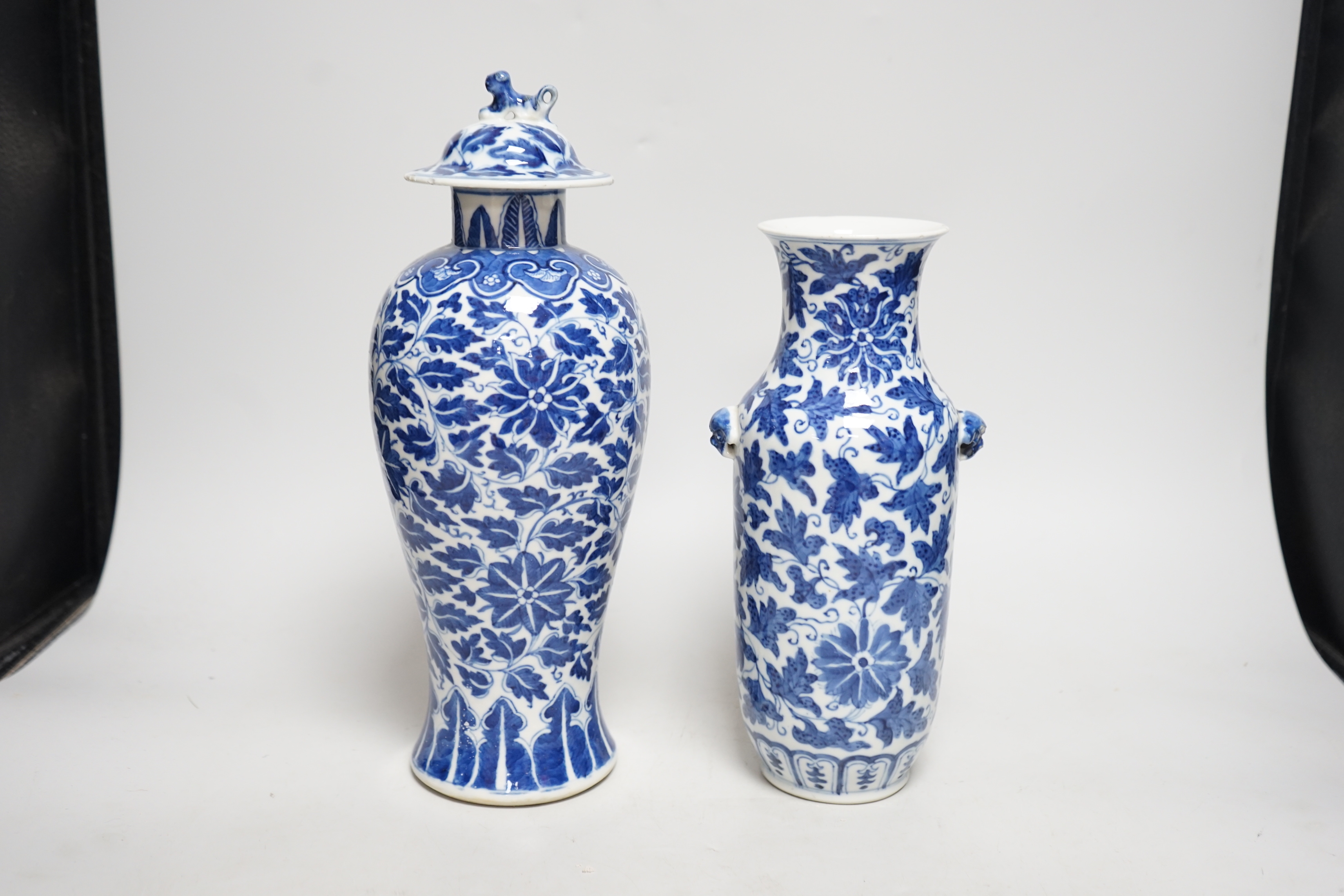 A late 19th century Chinese blue and white 'Lotus' vase and cover and another similar (2), tallest 31cm